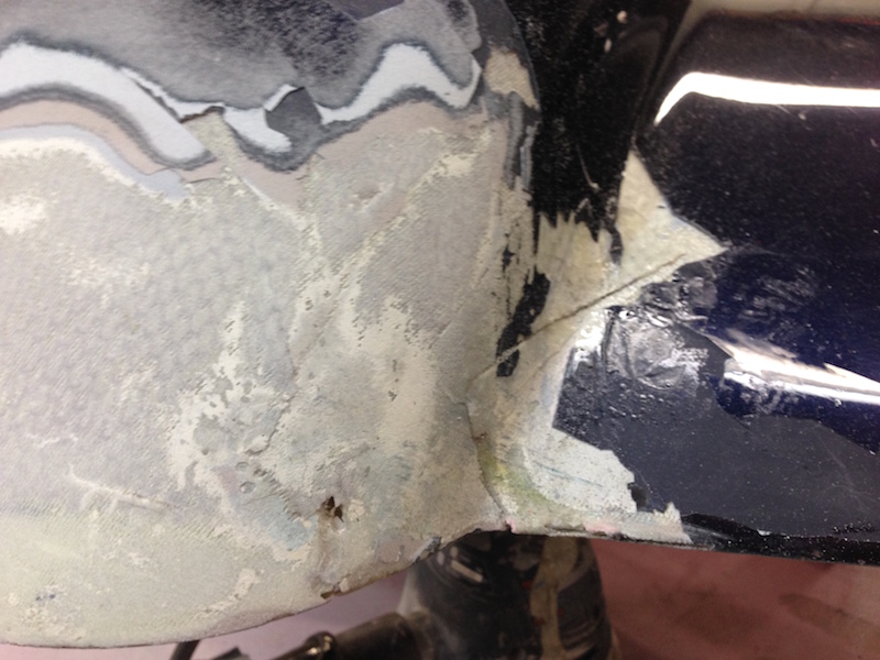 I sand into the cracks to make a trough in the fiberglass so I can lay in a repair section of fabric
